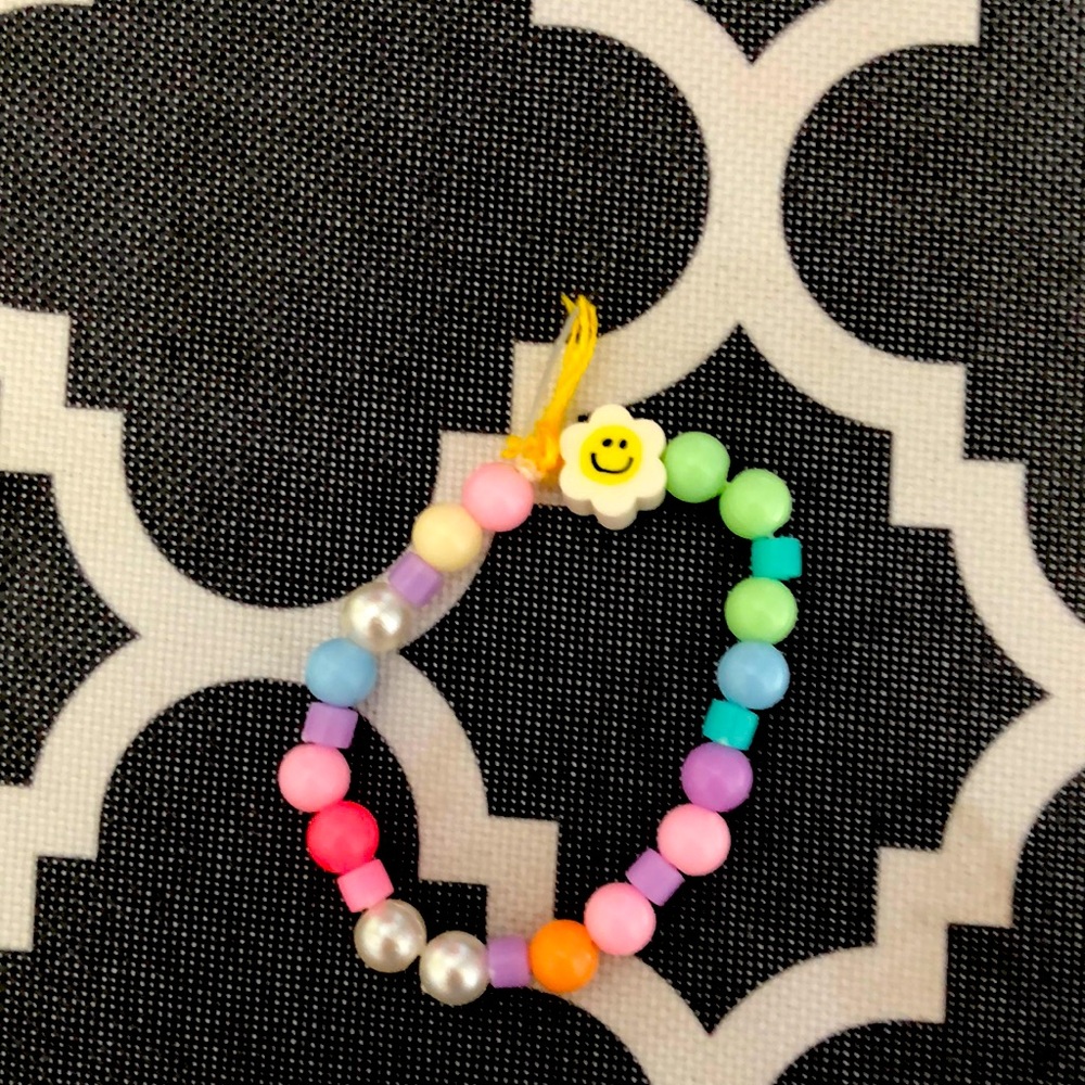 I am selling a bracelet with a smiley face flower